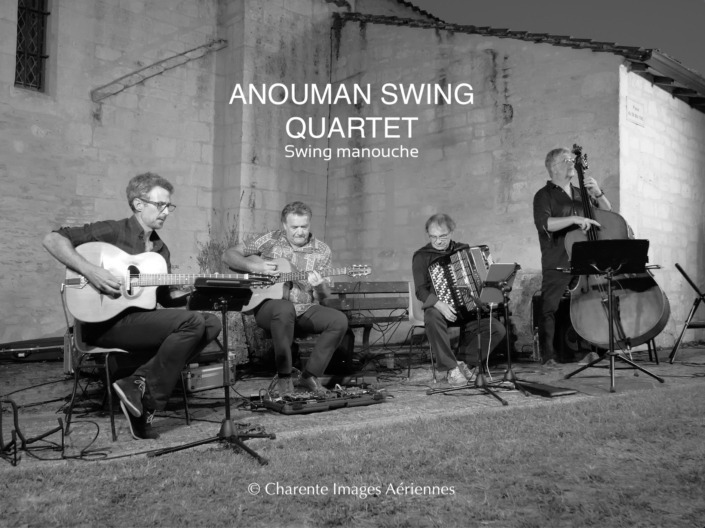 Concert en extérieur d'Anouman Swing Quartet où les 4 musiciens jouent des morceaux de swing manouche.